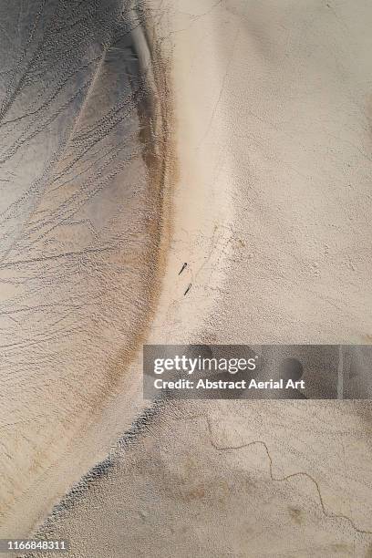 high angle view of two people walking on dune of pilat, france - arcachon stock pictures, royalty-free photos & images