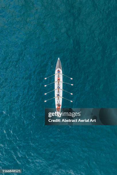 rowboat on the ocean as seen from above, france - remo de competición fotografías e imágenes de stock