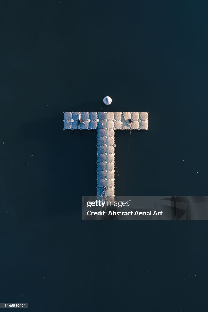 Drone shot above a T-shaped Jetty, France