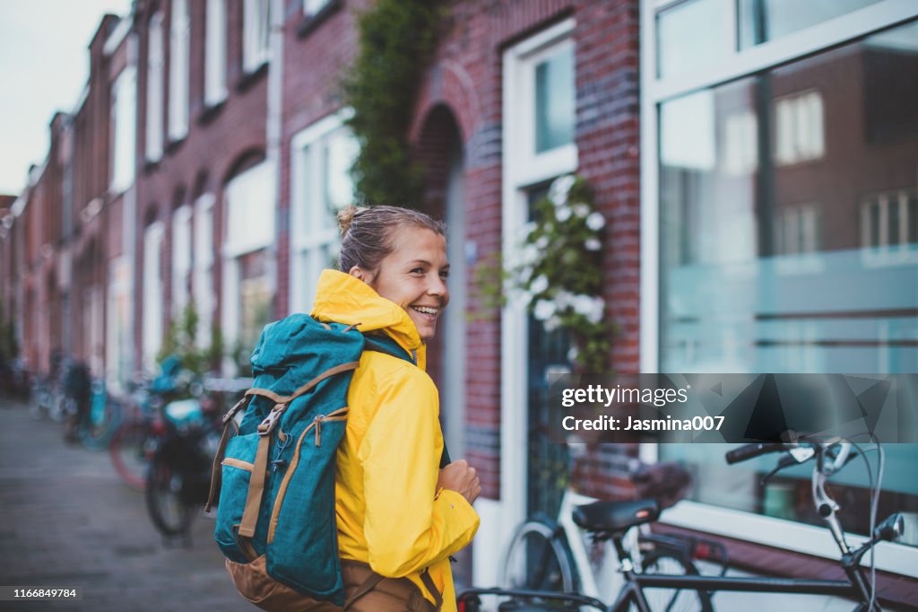 Smiling student walking at the street