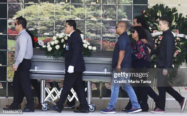 Pallbearers wheel the casket of Elsa Mendoza Marquez, a Mexican schoolteacher and principal who was killed in the El Paso mass shooting, toward mass...