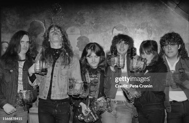 From left to right, bassist Cliff Burton, singer and guitarist James Hetfield and drummer Lars Ulrich of American heavy metal band Metallica drinking...