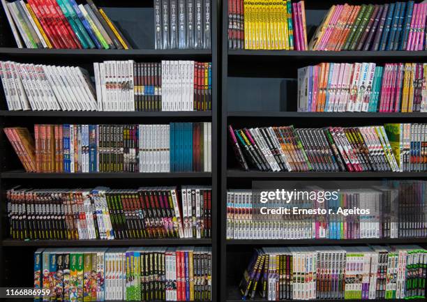 store shelves filled with manga comic books - anime stock pictures, royalty-free photos & images