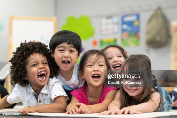 group of smiling preschool students - toddler stock pictures, royalty-free photos & images
