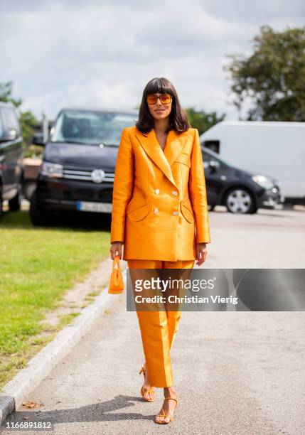 Babba Rivera is seen wearing orange suit outside By Malene Birger during Copenhagen Fashion Week Spring/Summer 2020 on August 08, 2019 in Copenhagen,...