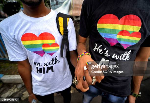 Young Gay couple of LGBT Community hold their hands before attending the Queer march. The historic verdict on partial decriminalization of Section...