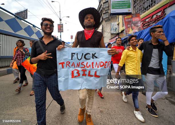 Members of Lesbian, Gay, Bisexual and Transgender Community hold a placard that says fuck the transgender bill during the Queer march. The historic...