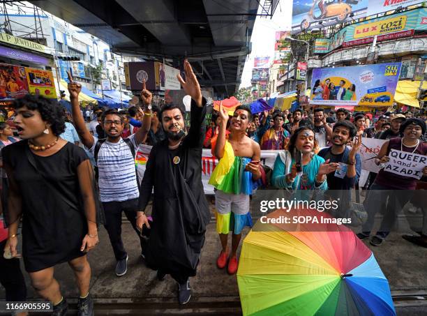 Members of Lesbian, Gay, Bisexual and Transgender Community hold placards while shouting slogans during the Queer march. The historic verdict on...