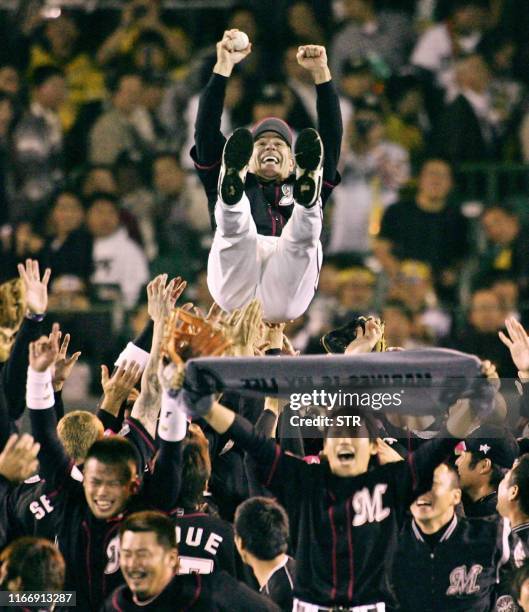 Chiba Lotte Marines manager Bobby Valentine and former New York Mets manager, is tossed into the air after their 3-2 victory over the Hanshin Tigers...