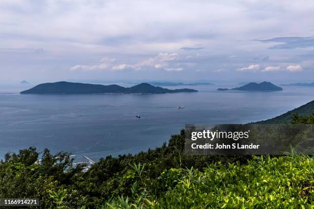 Islands seen off the coast of Takamatsu in the Inland Sea, or Seto Naikai as it is known in Japanese is the body of water separating Honshu, Shikoku...