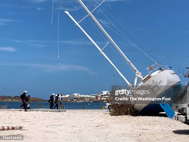 Booat called Still Restless flipped aground on Sunshine Park in Hope Town on Elbow Cay in The Bahamas during Hurricane Dorian. Members of the Coast...