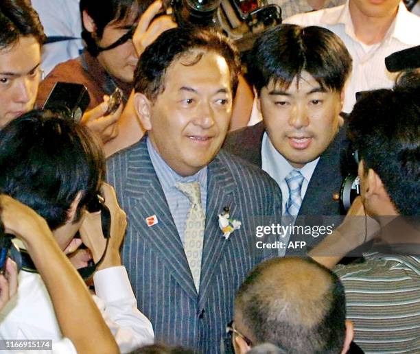 Yasuo Tanaka, governor of the Japanese prefecture of Nagano, is surrounded by the media at his campaign office in Nagano, central Japan, 06 August...
