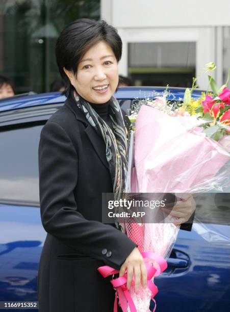 Japan's Environment Minister Yuriko Koike, who was hospitalized for treatment of acute pneumonia, appears to the press as she is discharged from...