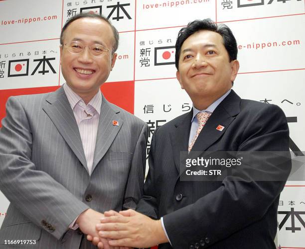 Yasuo Tanaka , leader of New Party Nippon shakes hands with party candidate for the upcoming Upper House election and a freelance journalist Yoshifu...