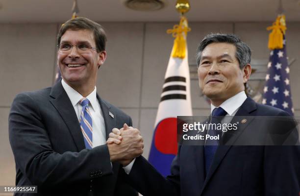 Defense Secretary Mark Esper shakes hands with South Korean Defense Minister Jeong Kyeong-doo after signing the guest book at Defense Ministry on...