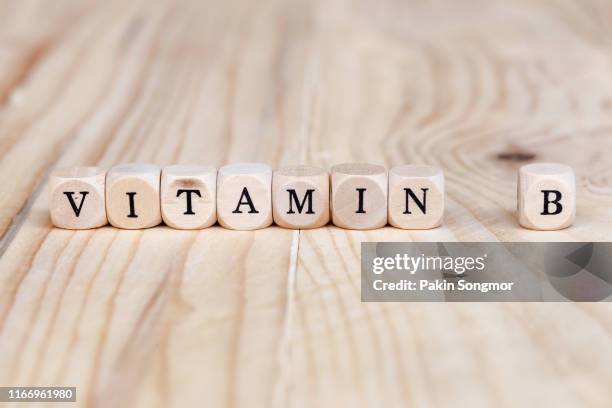 close up vitamin b word made from wooden letters on the table - b m stock pictures, royalty-free photos & images