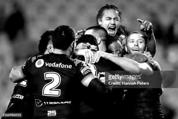 The Warriors celebrate after Jazz Tevaga of the Warriors scored a try during the round 21 NRL match between the New Zealand Warriors and the Manly...