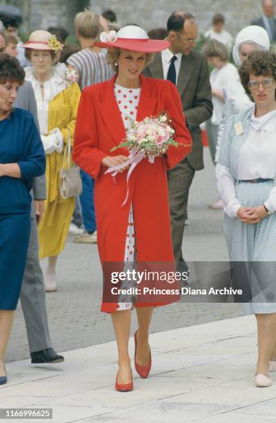 Diana, Princess of Wales wearing a red coat by Jan Van Velden during a visit to Atlantic College in Llantwit Major, Wales, June 1985.