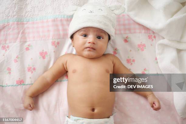 adorable baby boy on bed,close up - baby close up bed photos et images de collection