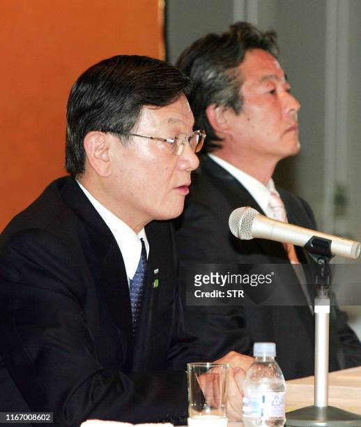 Japan's electronics giant Panasonic president Fumio Otsubo speaks at a press conference in Osaka on November 7 while Sanyo Electric president...