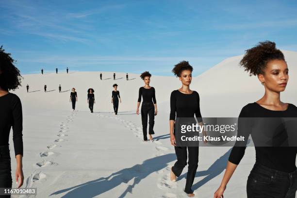 multiple image of young female models walking at desert - jeans barefoot fotografías e imágenes de stock