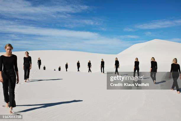 multiple image of young woman walking on sand at desert - つまらない仕事 ストックフォトと画像