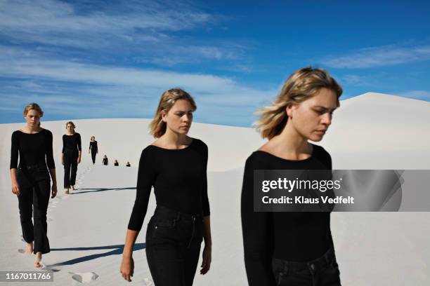 multiple image of woman walking at desert during sunny day - mühsal stock-fotos und bilder