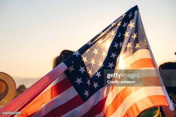 spreading american flag - fourth of july stock pictures, royalty-free photos & images