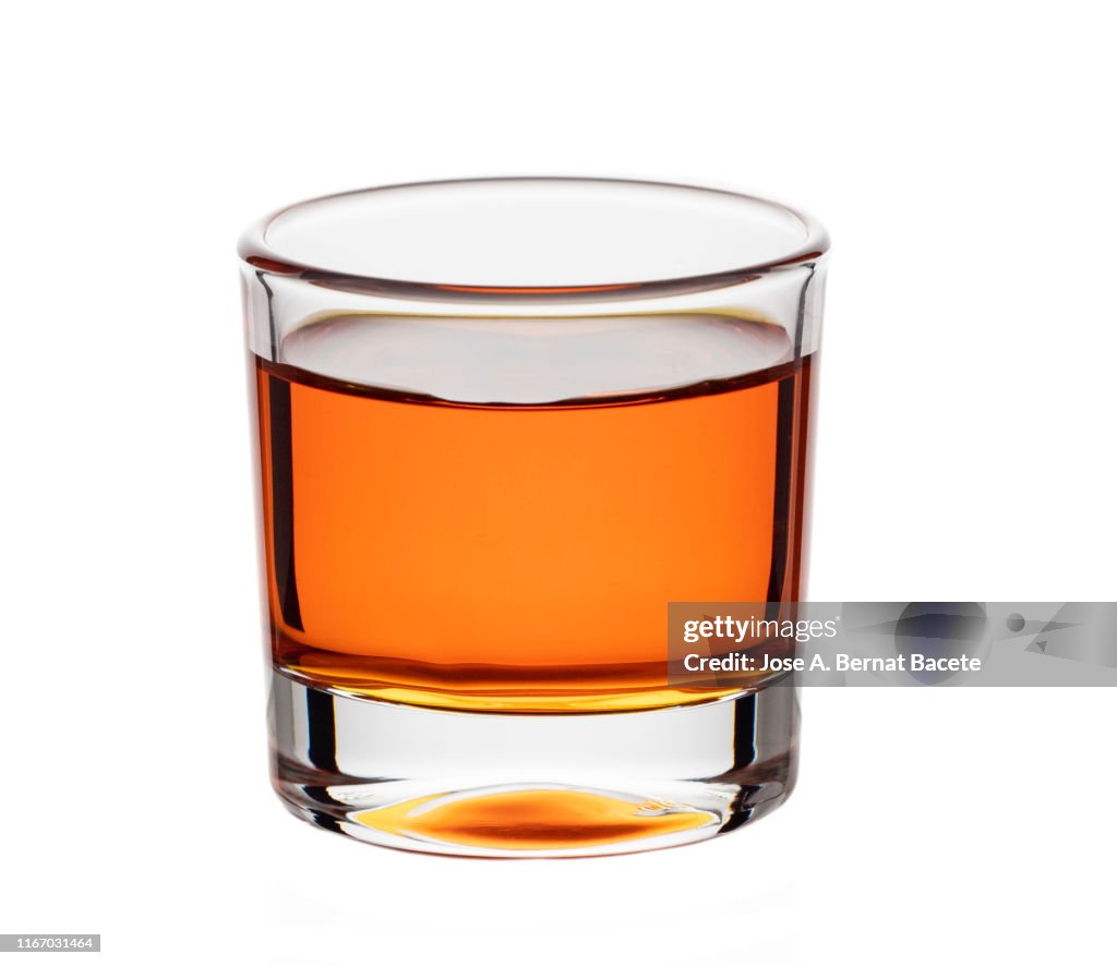 Shot glass filled with liquor isolated on white, (Shot of spirit).
