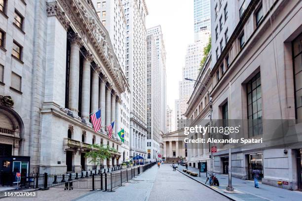 wall street and new york stock exchange in downtown manhattan, new york city, usa - manhattan financial district stock pictures, royalty-free photos & images