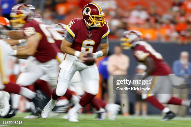 Josh Woodrum of the Washington Redskins drops back to hand off the ball during the game against the Cleveland Browns at FirstEnergy Stadium on August...