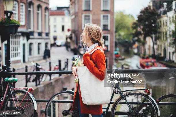 dutch woman with tulips - amsterdam stock pictures, royalty-free photos & images