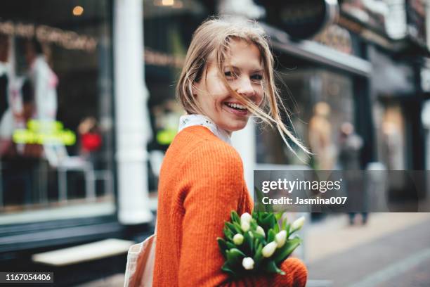 dutch woman with tulips in utrecht - netherlands people stock pictures, royalty-free photos & images