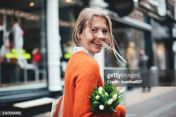 dutch woman with tulips in utrecht - netherlands stock pictures, royalty-free photos & images