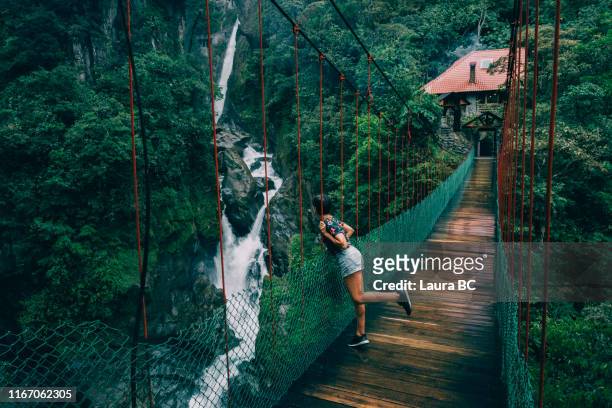young woman looking to a waterfall. - ecuador stock pictures, royalty-free photos & images