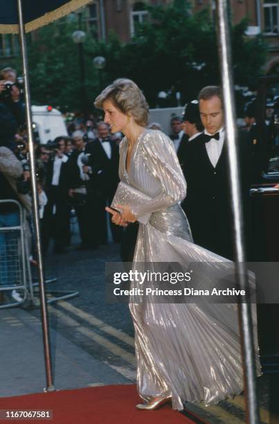 Diana, Princess of Wales attends the premiere of the James Bond film 'A View To a Kill' at the Empire Leicester Square in London, wearing a gold lame...