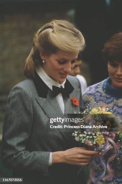 Diana, Princess of Wales visits a Dr Barnardo's children's home in Newham, London, 1984. She is wearing a grey coat by Jan Van Velden.