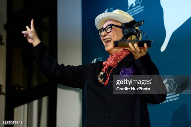 Chinese director Yonfan holds the Award for Best Screenplay he received for the movie &quot;No.7 Cherry Lane&quot; during the awards ceremony winners...