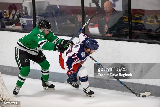 Ryan McGregor of the Columbus Blue Jackets protects the puck from Tanner Jago of the Dallas Stars during Day-4 of the NHL Prospects Tournament at...