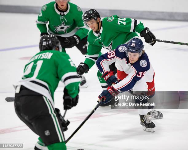 Tyler Angle of the Columbus Blue Jackets controls the puck in front of Riley Damiani of the Dallas Stars during Day-4 of the NHL Prospects Tournament...