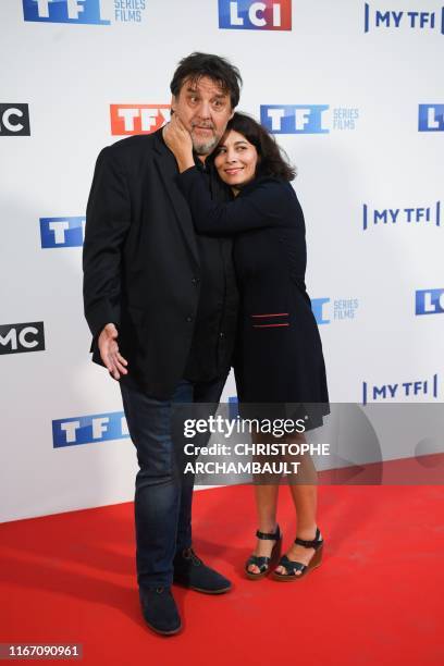 French actor Guy Lecluyse and French actress Cecile Rebboah pose during a photocall for the new broadcast programming season of French television...