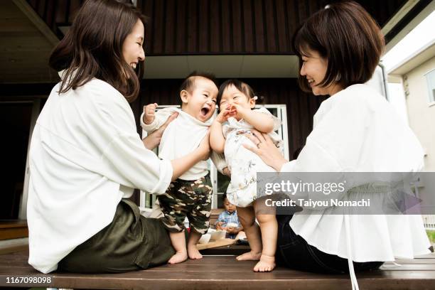 mothers playing with babies - cute japanese boy stock-fotos und bilder