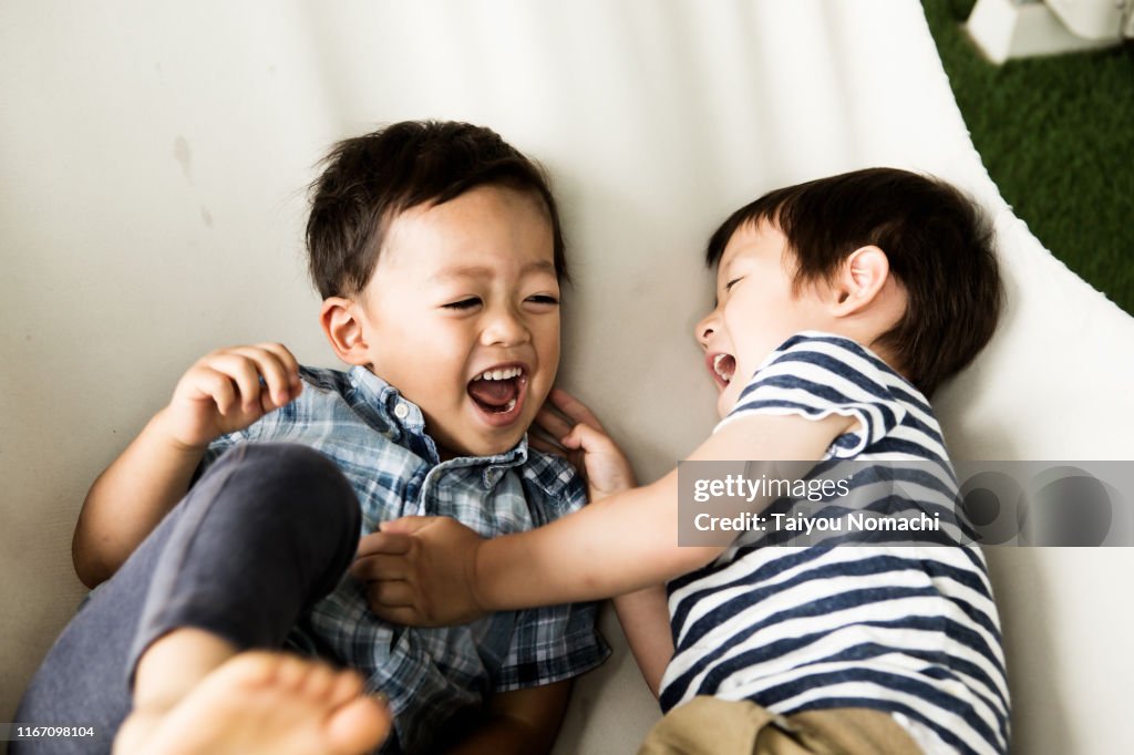 Boys playing in a hammock