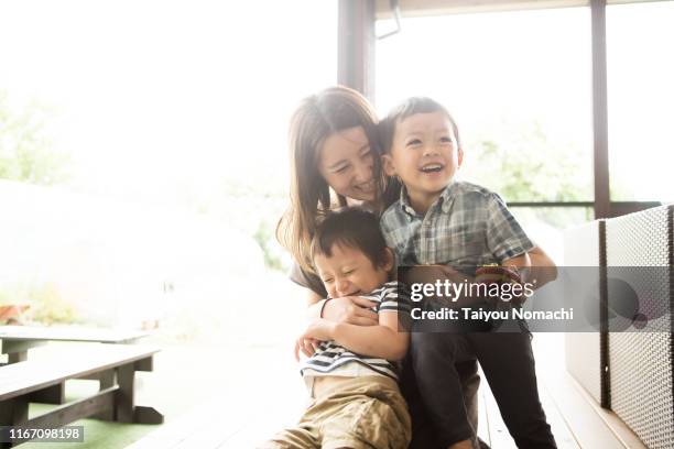 mother and son playing together - smiling controluce foto e immagini stock