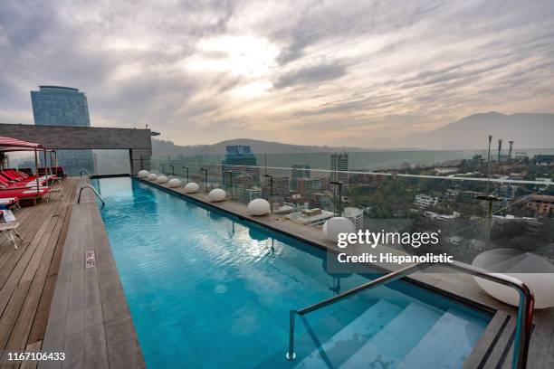 beautiful view of a rooftop pool and cityscape - no people - rooftop pool imagens e fotografias de stock