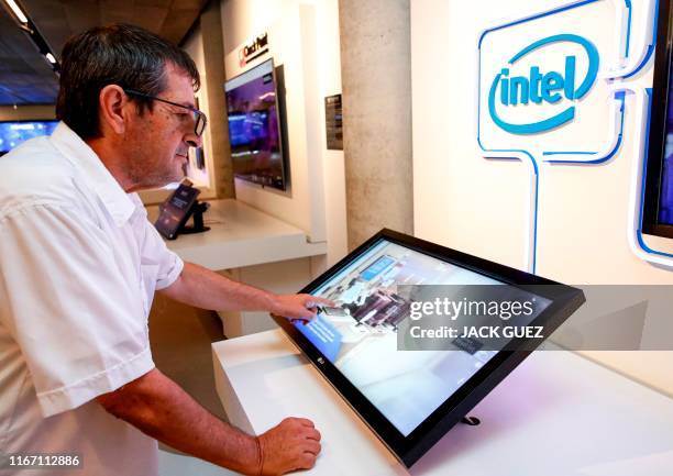 Visitor interacts with a display by Intel, at a technology exhibit at the Peres Center for Peace and Innovation in the Israeli coastal city of Tel...