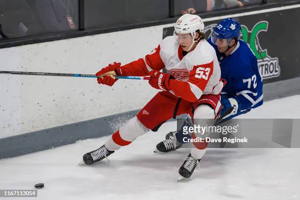 Moritz Seider of the Detroit Red Wings protects the puck from Colt Conrad of the Toronto Maple Leafs during Day-4 of the NHL Prospects Tournament at...