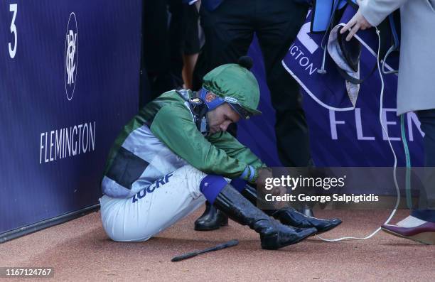 Jockey Michael Walker is seen feeling ill after race 5, VRC Member Jeffery Overington Handicap during Melbourne Racing at Flemington Racecourse on...