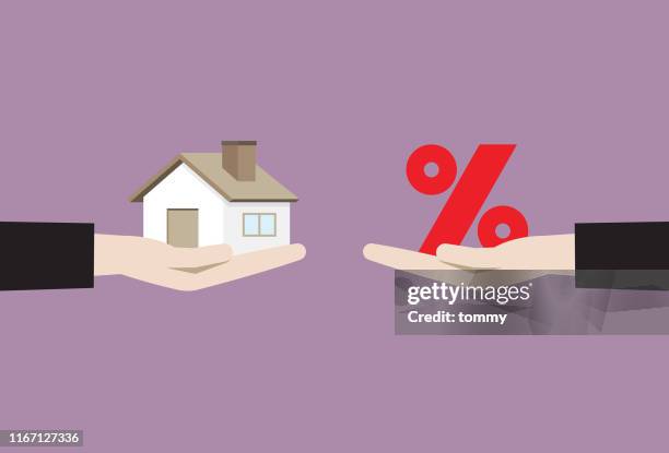 businessman hand holding house and percentage sign - interest rate stock illustrations