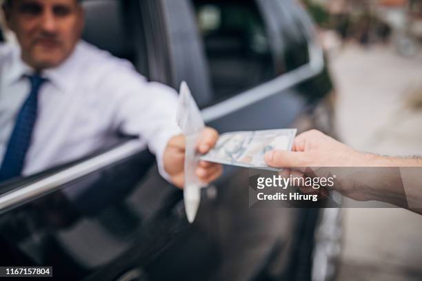man buying cocaine from drug dealer - crime board stock pictures, royalty-free photos & images